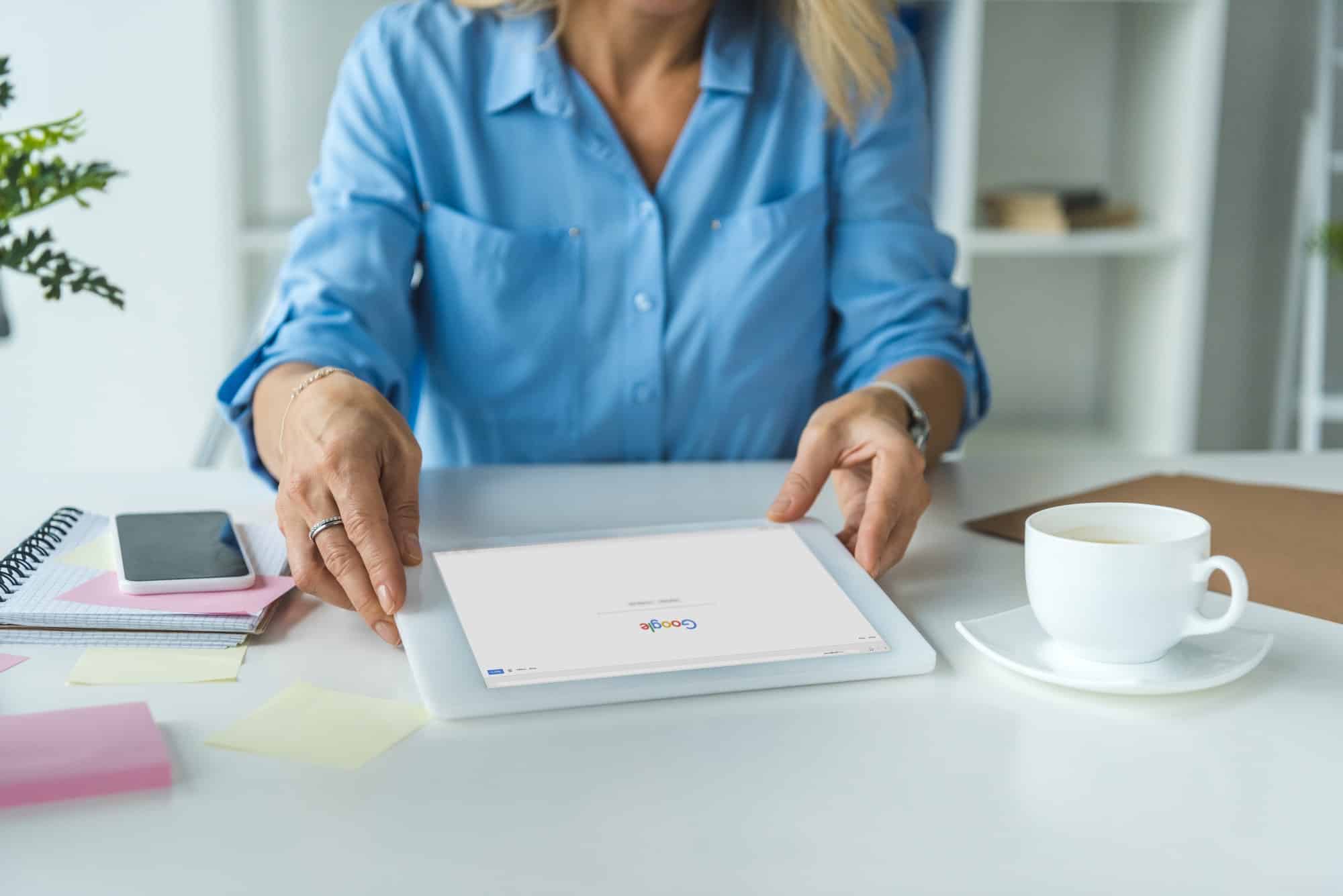 cropped view of businesswoman using digital tablet with Google website